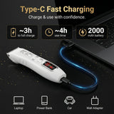 Hair clipper with USB cable connected to a laptop, charging information displayed.