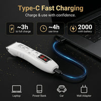 Hair clipper with USB cable connected to a laptop, charging information displayed.